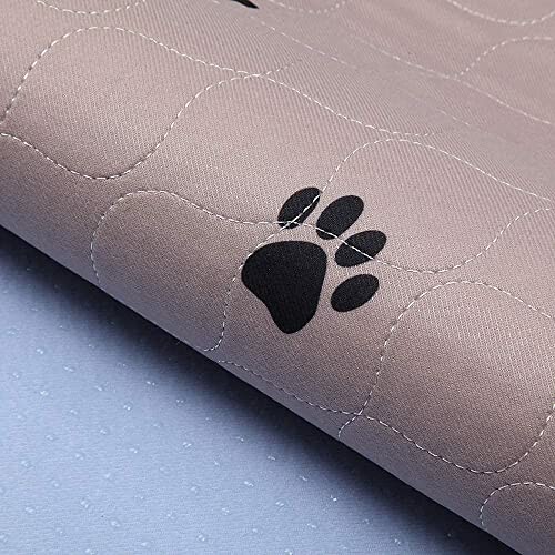 Quilted fabric with a black paw print design.