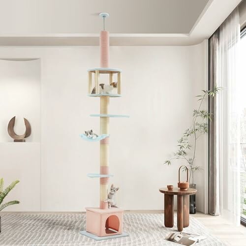 Tall cat tree with multiple platforms and kittens in a modern living room.