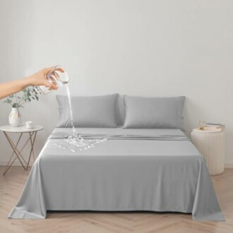 Water being poured on a waterproof bed sheet.